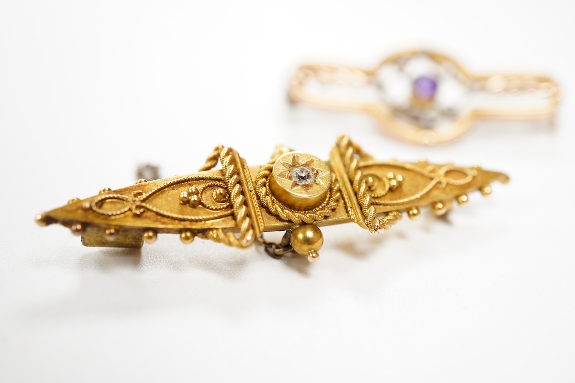 A Victorian 15ct and diamond set navette shaped Etruscan style brooch (lacking pin), 46mm, gross weight 3.5 grams, a 9ct, amethyst and seed pearl set bar brooch and a 9ct, garnet and split pearl set wreath brooch, gross